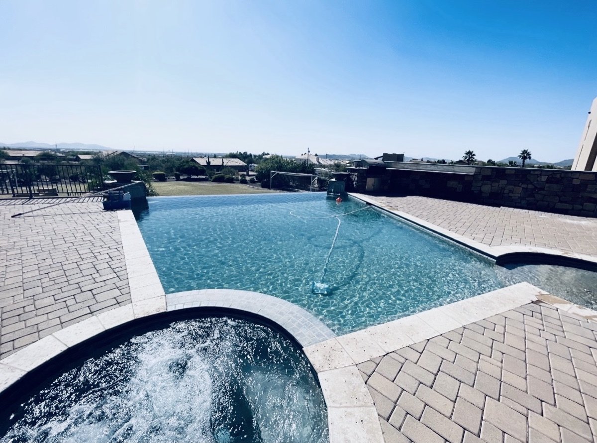 Spa and infinity-edge pool with desert mountain views