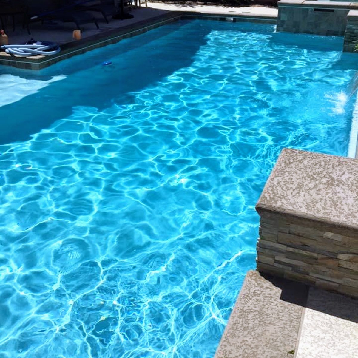 Crystal clear blue pool water after cleaning